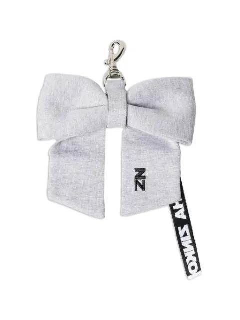 bow-detail logo-patch bag charm by NATASHA ZINKO