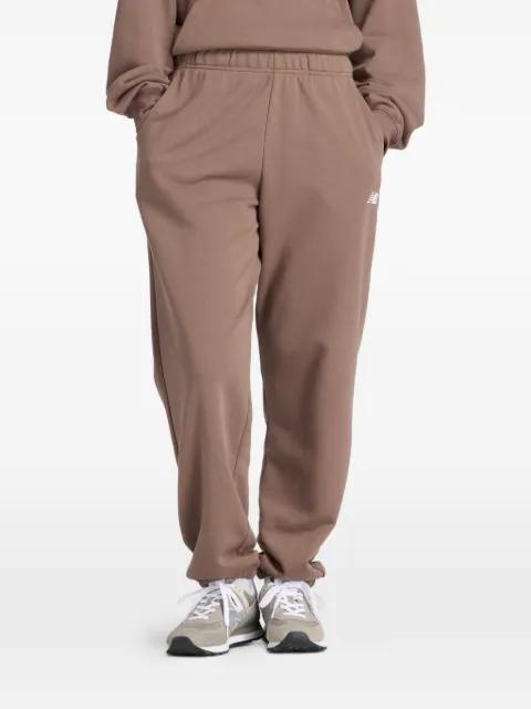 logo-embroidererd track pants by NEW BALANCE