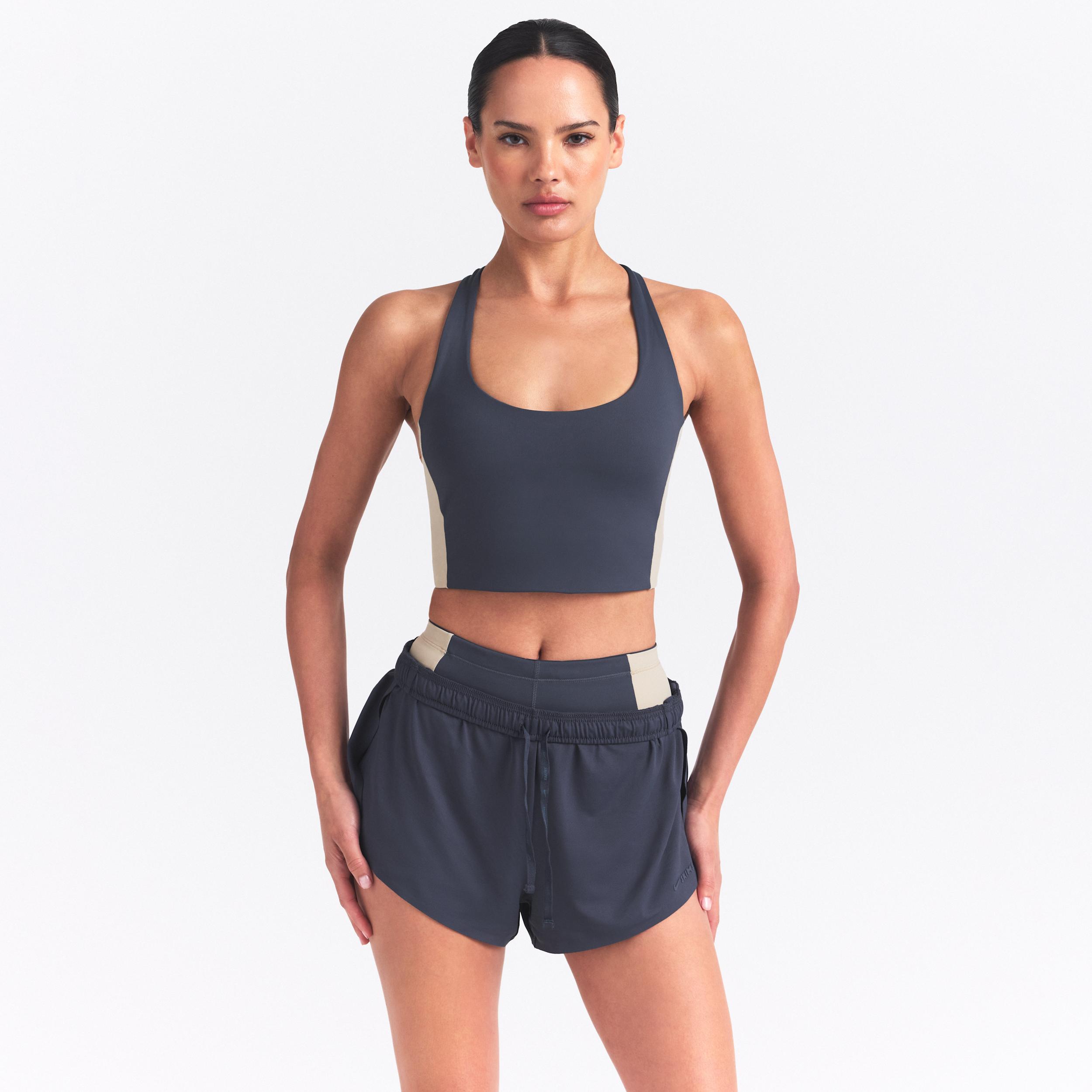 Nike Women's SKIMS Matte Shine Mix T-Back Bra by NIKE