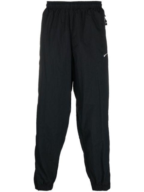 Solo Swoosh track pants by NIKE