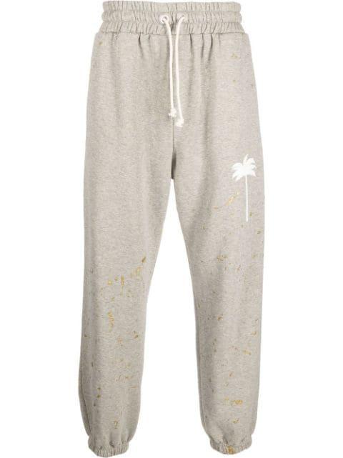 paint splatter track pants by PALM ANGELS
