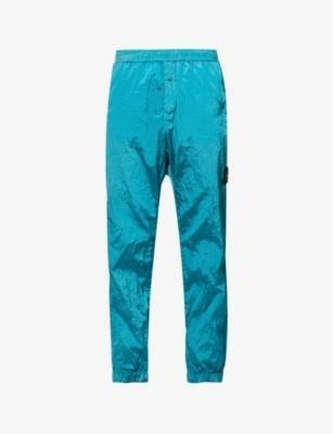 Brand-badge tapered-leg shell jogging bottoms by STONE ISLAND