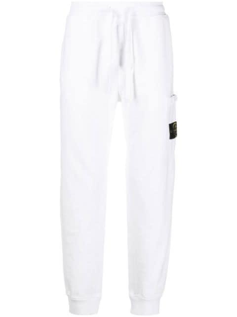 Compass-motif track pants by STONE ISLAND