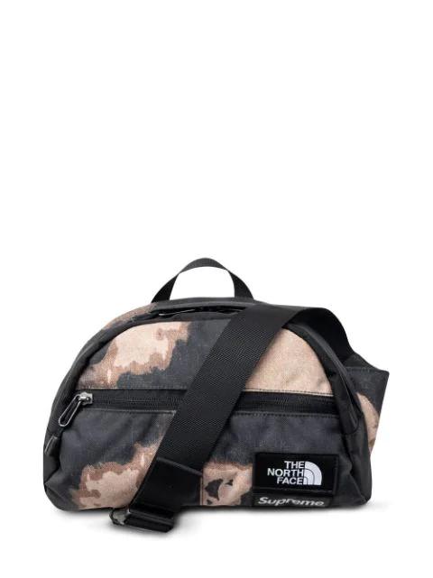 x The North Face Roo II bleached denim-print bag by SUPREME