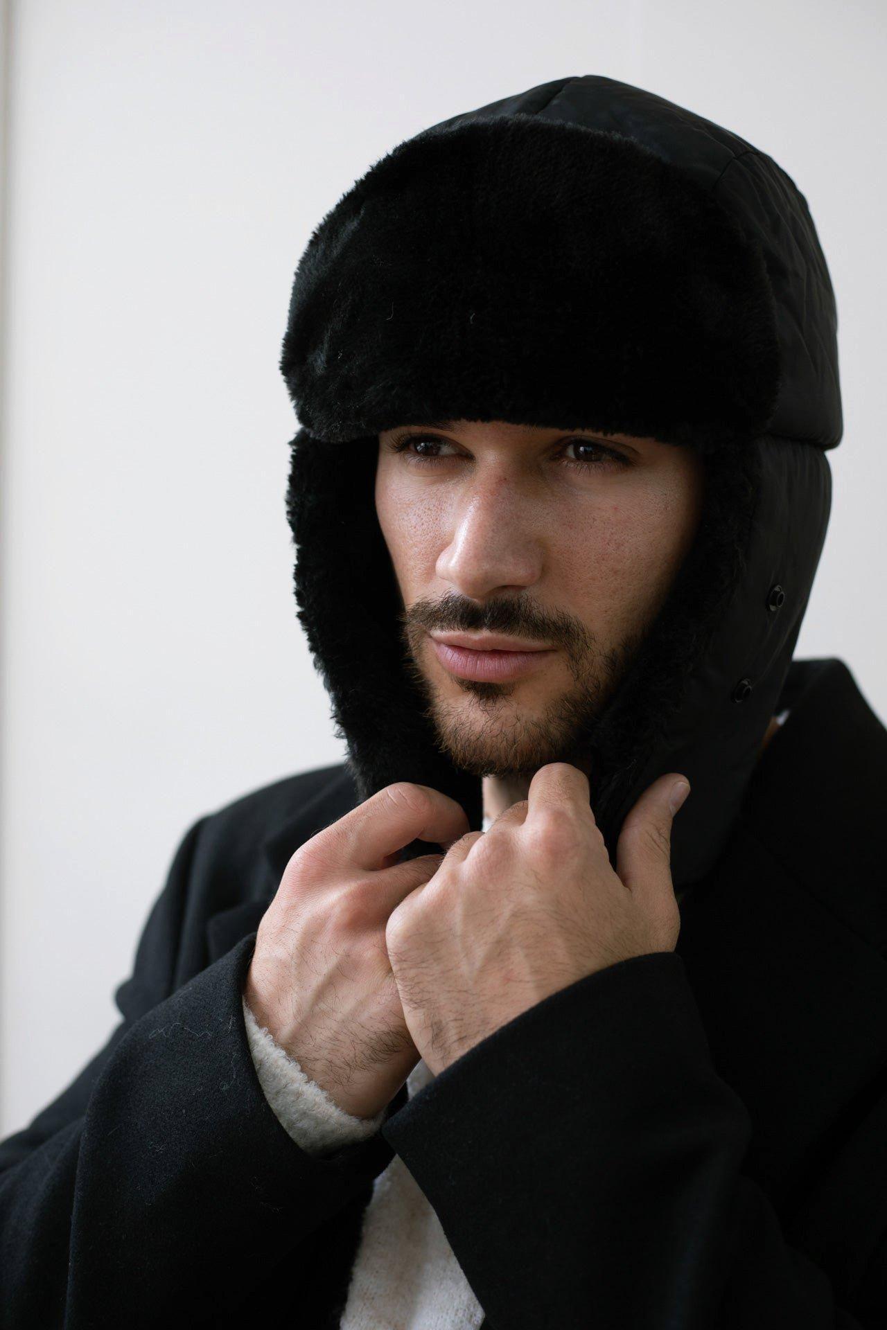Black Lined Trapper Hat With Detachable Mouth Cover by SVNX