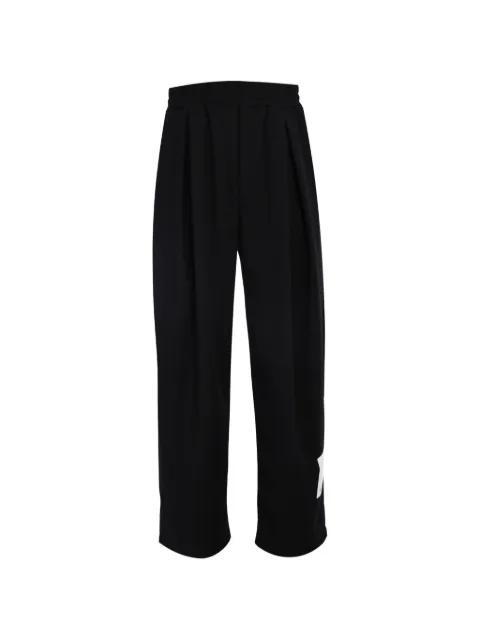 Rip-off pleated logo-patch trousers by TEE LIBRARY
