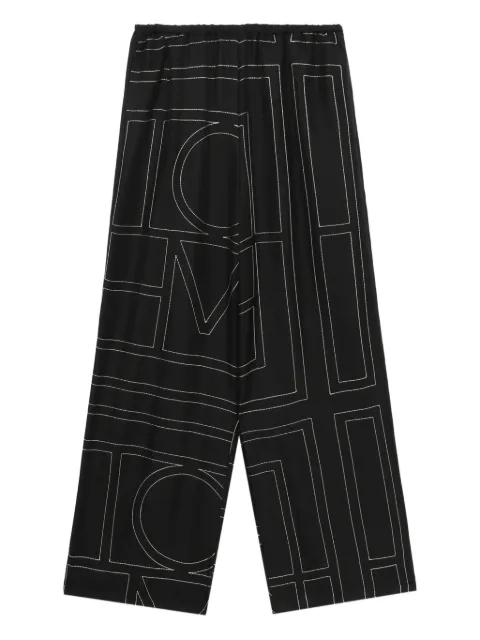 Monogram silk pajama bottoms by TOTEME