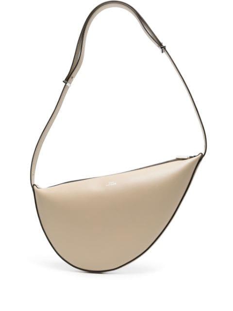 Scooped sling leather shoulder bag by TOTEME