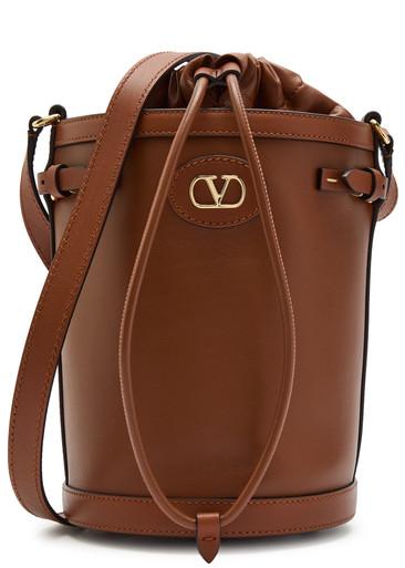 Logo-plaque leather drawstring bucket bag by VALENTINO