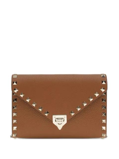 rockstud leather clutch bag by VALENTINO