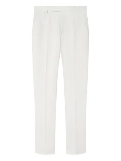 logo-patch trousers by VERSACE