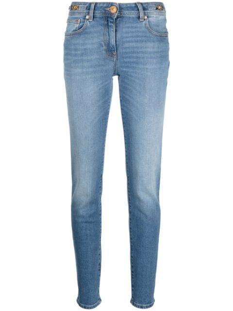 low-rise Medusa Head-motif skinny jeans by VERSACE