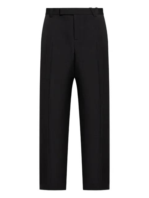 wool button fly trousers by VERSACE