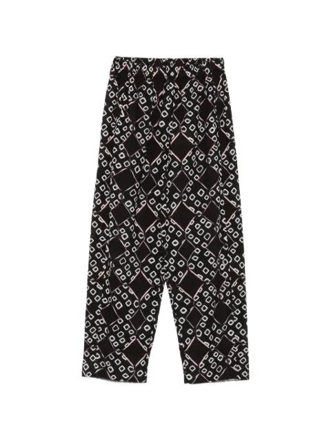 Triya geometric-pattern trousers by YAVI