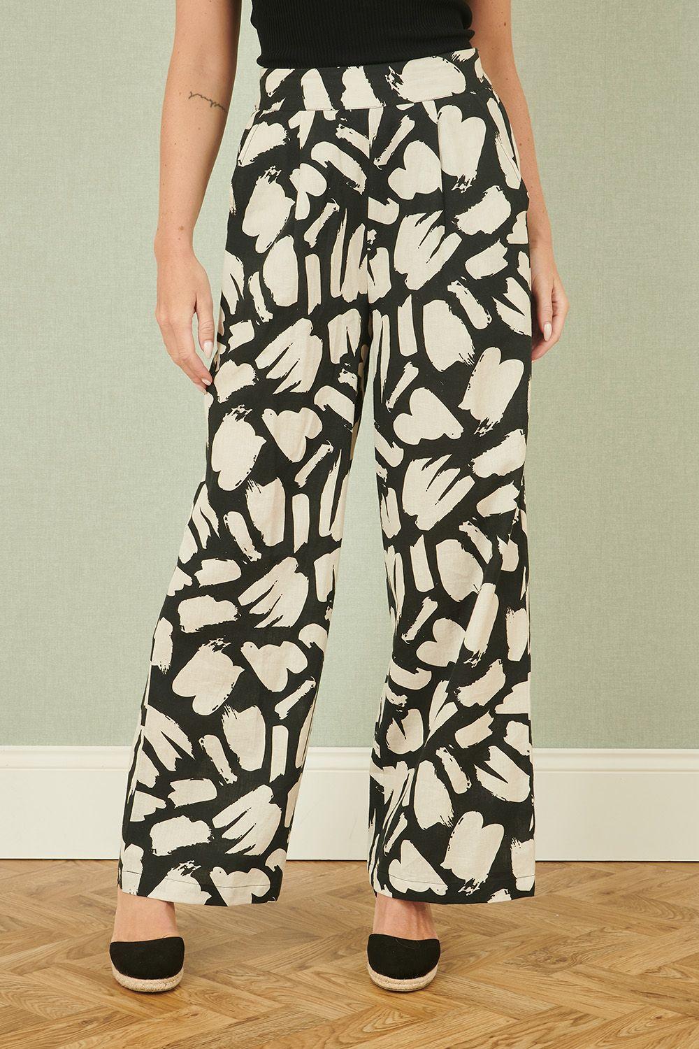 Black Cotton Splash Print Relaxed Fit Trousers by YUMI