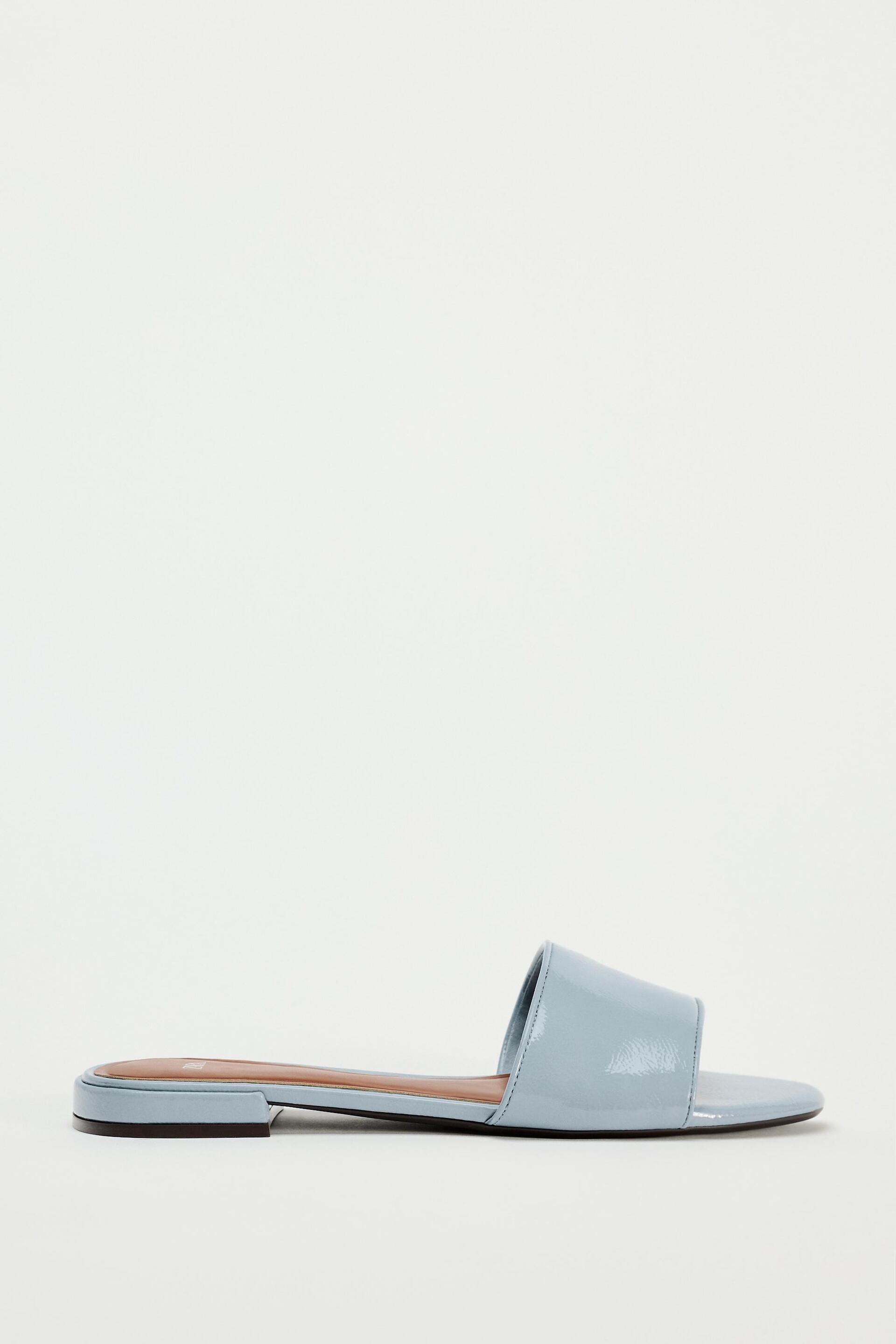 FAUX PATENT LEATHER FLAT SANDALS by ZARA