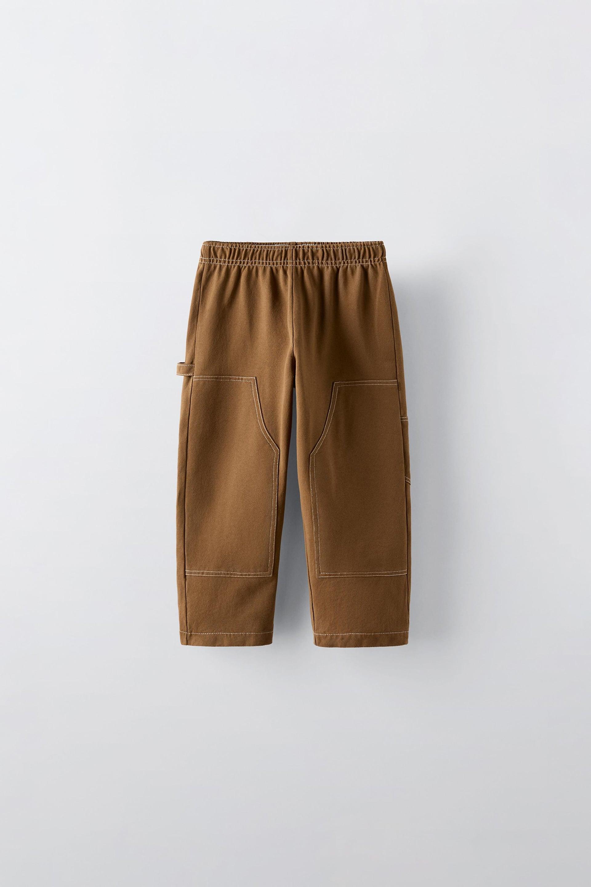 Pants with elastic waistband. Back patch pockets. Front knee patches and topstitching at seams. by ZARA